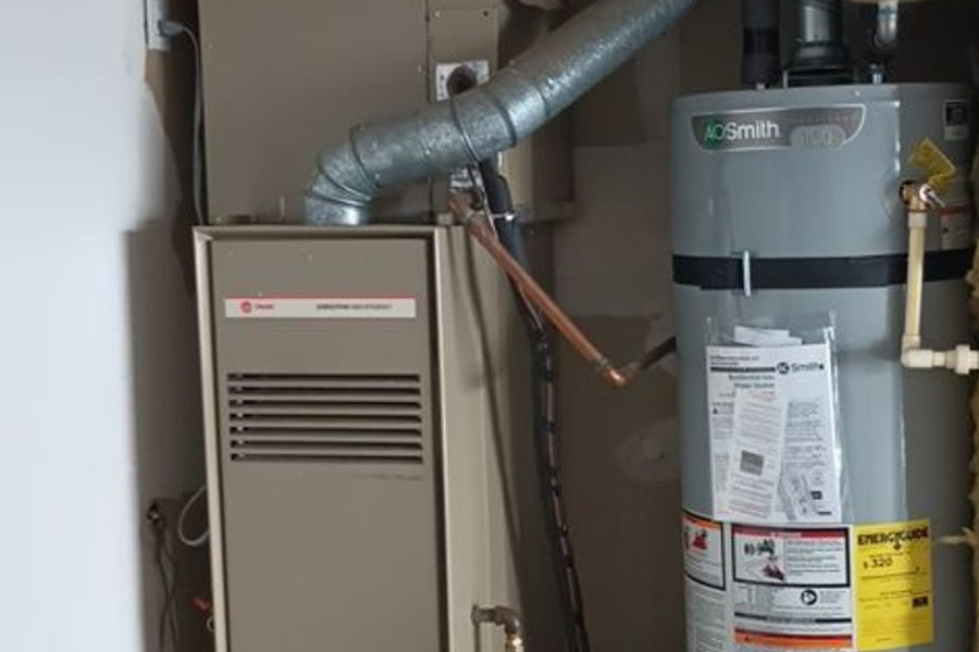 Gas furnace and water heater installed together in residential utility room