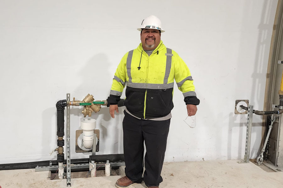 plumber in safety gear on site