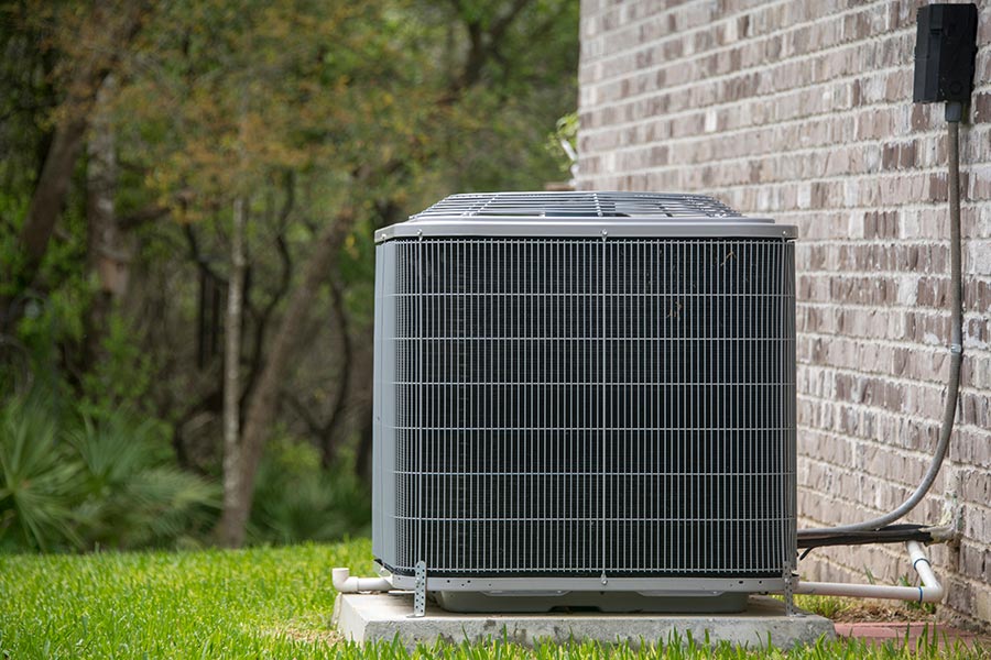 Outdoor air conditioning unit by wall