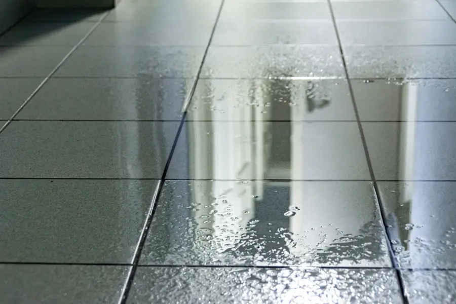 Water leak on tiled bathroom floor